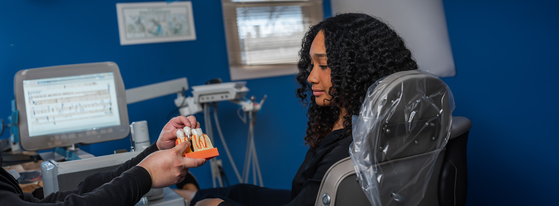 A person receiving dental care from a professional in an office setting.