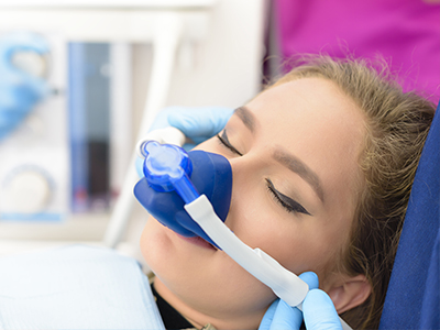A person receiving oxygen therapy while lying on a medical bed.